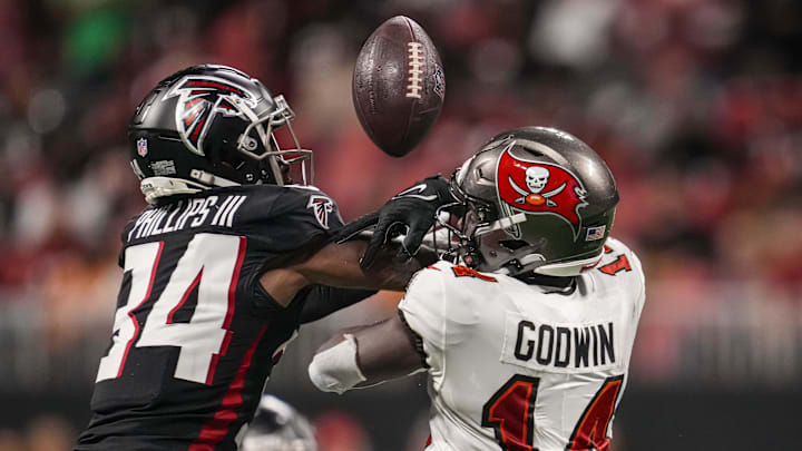 Dec 10, 2023; Atlanta, Georgia, USA; Atlanta Falcons cornerback Clark Phillips III (34) breaks up a pass against Tampa Bay Buccaneers wide receiver Chris Godwin (14) during the second half at Mercedes-Benz Stadium. Mandatory Credit: Dale Zanine-Imagn Images