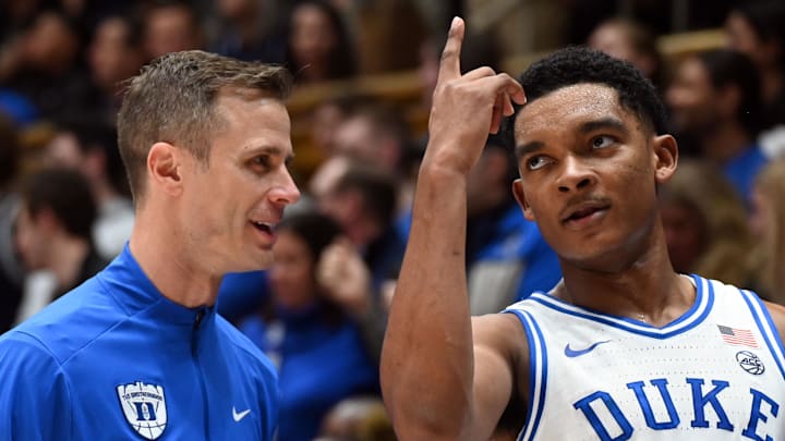 Feb 28, 2026; Durham, North Carolina, USA; Duke Blue Devils guard Caleb Foster (1) gestures to head coach Jon Scheyer during the second half against the Virginia Cavaliers at Cameron Indoor Stadium.   Duke won 77-51.  Mandatory Credit: Rob Kinnan-Imagn Images