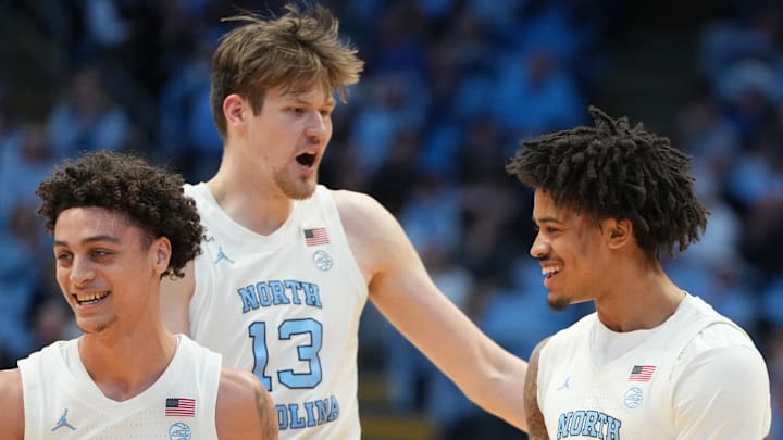 Feb 2, 2026; Chapel Hill, North Carolina, USA; North Carolina Tar Heels guard Kyan Evans (0) and center Henri Veesaar (13) and forward Jonathan Powell (11) react in the first half at Dean E. Smith Center. Mandatory Credit: Bob Donnan-Imagn Images