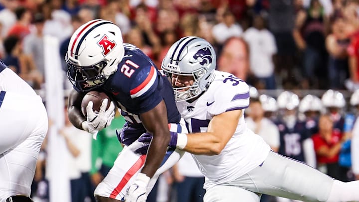 Sep 12, 2025; Tucson, Arizona, USA; Kansas State Wildcats linebacker Gabe Powers (35) tackles Arizona Wildcats running back Ismail Mahdi (21) during the second quarter of the game at Arizona Stadium. Mandatory Credit: Aryanna Frank-Imagn Images