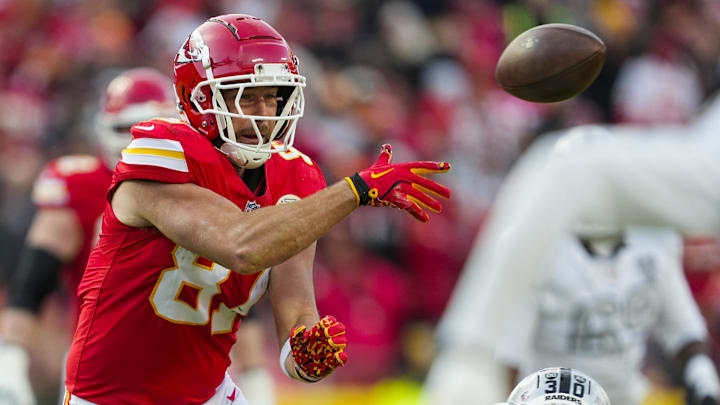 Nov 29, 2024; Kansas City, Missouri, USA; Kansas City Chiefs tight end Travis Kelce (87) laterals the ball during the first half against the Las Vegas Raiders at GEHA Field at Arrowhead Stadium. Mandatory Credit: Jay Biggerstaff-Imagn Images