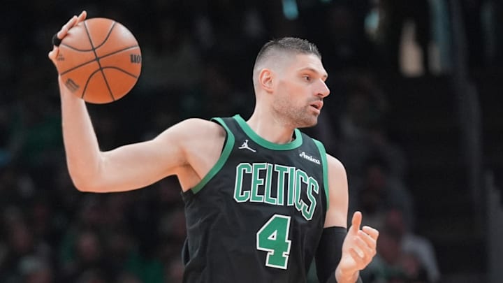 Apr 5, 2026; Boston, Massachusetts, USA; Boston Celtics center Nikola Vucevic (4) receives a pass against Toronto Raptors forward Collin Murray-Boyles (12) during the second half at TD Garden. Mandatory Credit: Gregory Fisher-Imagn Images