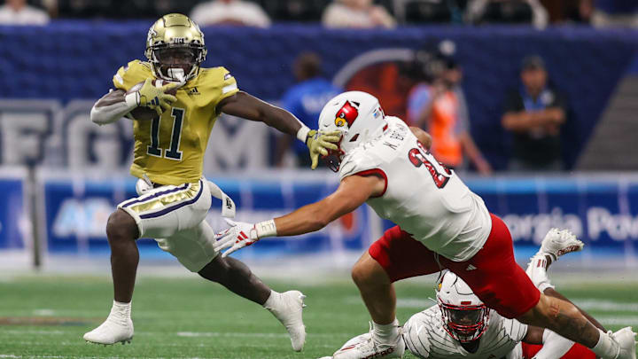 Sep 1, 2023; Atlanta, Georgia, USA; Georgia Tech Yellow Jackets running back Jamal Haynes (11) runs past Louisville Cardinals linebacker Keith Brown (22) in the second quarter at Mercedes-Benz Stadium. Mandatory Credit: Brett Davis-Imagn Images