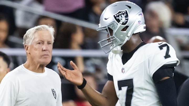 Aug 23, 2025; Glendale, Arizona, USA; Las Vegas Raiders quarterback Geno Smith (7) talks to head coach Pete Carroll against the Arizona Cardinals during a preseason NFL game at State Farm Stadium. Mandatory Credit: Mark J. Rebilas-Imagn Images