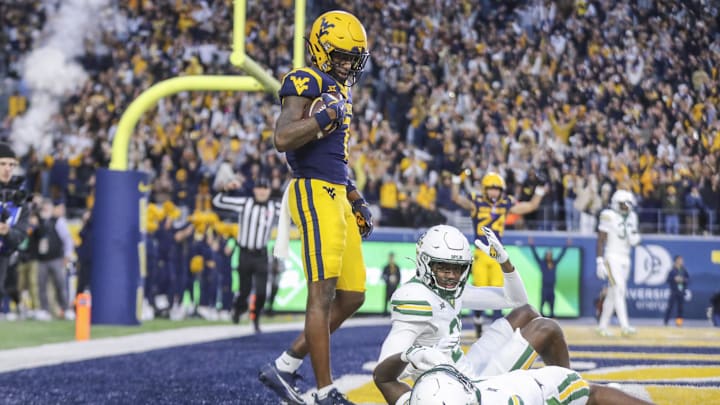 Nov 16, 2024; Morgantown, West Virginia, USA; West Virginia Mountaineers wide receiver Traylon Ray (7) catches a pass for a touchdown during the second quarter against the Baylor Bears at Mountaineer Field at Milan Puskar Stadium. Mandatory Credit: Ben Queen-Imagn Images Nov 16, 2024; Morgantown, West Virginia, USA; West Virginia Mountaineers wide receiver Traylon Ray (7) catches a pass for a touchdown during the second quarter against the Baylor Bears at Mountaineer Field at Milan Puskar Stadium. Mandatory Credit: Ben Queen-Imagn Images