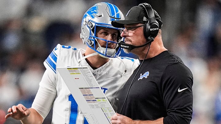 Detroit Lions quarterback Jared Goff (16) talks to head coach Dan Campbell before a play against Dallas Cowboys 