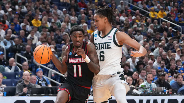 Mar 21, 2026; Buffalo, NY, USA; Louisville Cardinals guard Kobe Rodgers (11) drives the ball against Michigan State Spartans forward Jordan Scott (6) in the first half during a second round game of the men's 2026 NCAA Tournament at Keybank Center. Mandatory Credit: Gregory Fisher-Imagn Images Mar 21, 2026; Buffalo, NY, USA; Louisville Cardinals guard Kobe Rodgers (11) drives the ball against Michigan State Spartans forward Jordan Scott (6) in the first half during a second round game of the men's 2026 NCAA Tournament at Keybank Center. Mandatory Credit: Gregory Fisher-Imagn Images