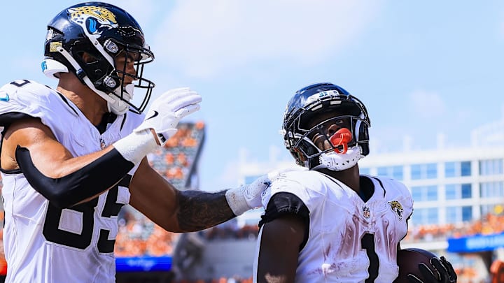Sep 14, 2025; Cincinnati, Ohio, USA; Jacksonville Jaguars tight end Brenton Strange (85) reacts after running back Travis Etienne Jr. (1) scores a touchdown in the second half against the Cincinnati Bengals at Paycor Stadium. Mandatory Credit: Katie Stratman-Imagn Images