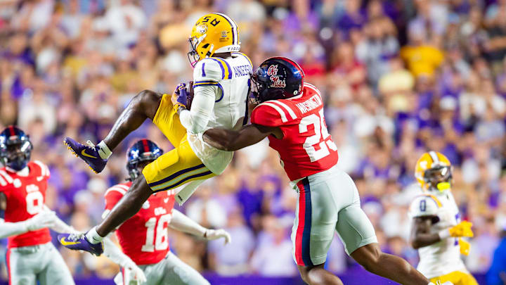 Aaron Anderson makes a catch and is taken down by Rebels' Trey Washington 