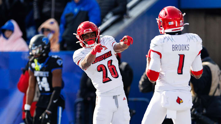 Nov 30, 2024; Lexington, Kentucky, USA; Louisville Cardinals running back Duke Watson (26) celebrates a touchdown with wide receiver Ja'Corey Brooks (1) during the second quarter against the Kentucky Wildcats at Kroger Field. 