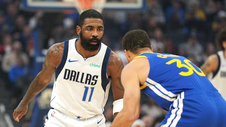 Dallas Mavericks guard Kyrie Irving (11) defends against Golden State Warriors guard Stephen Curry (30) during the first quarter at Chase Center. Mandatory Credit: Darren Yamashita-Imagn Images