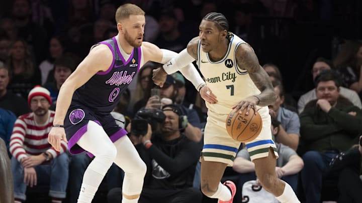 Dec 21, 2025; Minneapolis, Minnesota, USA; Milwaukee Bucks guard Kevin Porter Jr. (7) dribbles the ball as Minnesota Timberwolves guard Donte Divincenzo (0) plays defense in the second half at Target Center. Mandatory Credit: Jesse Johnson-Imagn Images