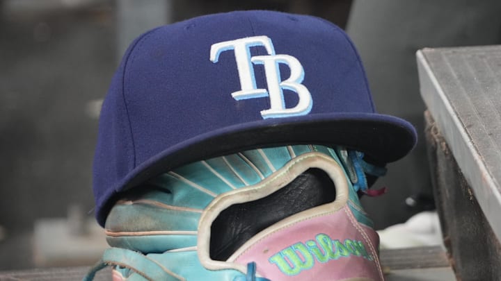 Sep 26, 2025; Toronto, Ontario, CAN; The hat and glove of Tampa Bay Rays third baseman Junior Caminero (13) in the dugout during the game against the Toronto Blue Jays at Rogers Centre. 