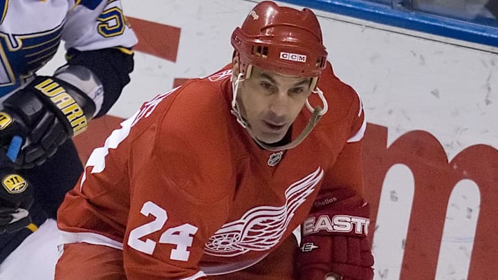 March 25, 2008; St, Louis, MO, USA; Detroit Red Wings defenseman Chris Chelios (24) handles the puck in front of St. Louis Blues right wing Cam Janssen (55) during the 2nd period at the Scottrade Center. Mandatory Credit: Jeff Curry-Imagn Images