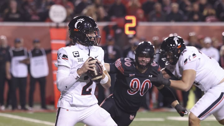 Cincinnati Bearcats quarterback Brendan Sorsby (2) looks to pass against Utah Utes defensive end John Henry Daley (90) during the second half at Rice-Eccles Stadium.