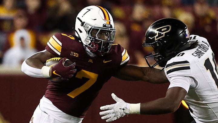 Minnesota running back Fame Ijeboi (7) runs the ball as Purdue linebacker Alex Sanford (10) defends.