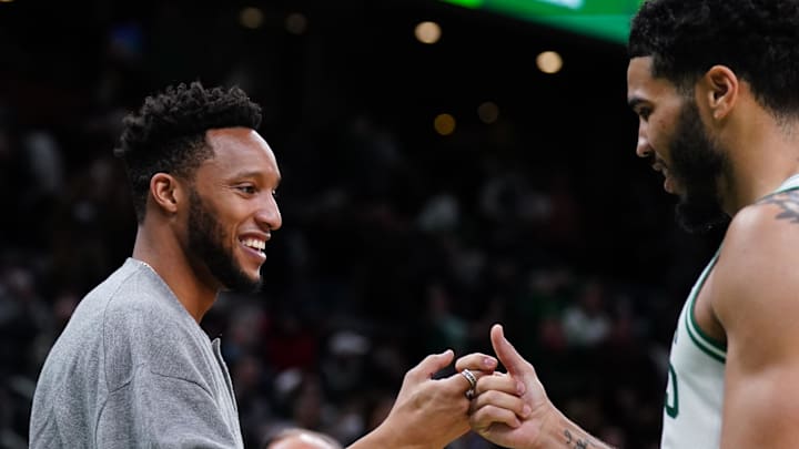 Mar 1, 2022; Boston, Massachusetts, USA; Former NBA player and former assistant coach for the Boston Celtics Evan Turner greets forward Jayson Tatum (0) during a break in the action against the Atlanta Hawks in the second half at TD Garden. Mandatory Credit: David Butler II-Imagn Images