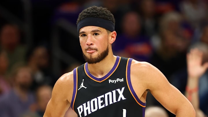 Apr 14, 2026; Phoenix, Arizona, USA; Phoenix Suns guard Devin Booker (1) reacts against the Portland Trail Blazers in the first half during the play-in rounds of the 2026 NBA Playoffs at Mortgage Matchup Center. Mandatory Credit: Mark J. Rebilas-Imagn Images