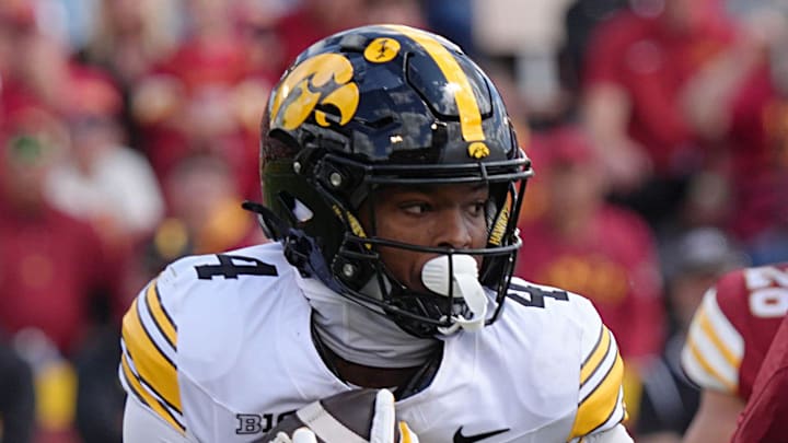Iowa Hawkeyes running back Jaziun Patterson (4) runs with the ball asIowa State Cyclones' linebacker Beau Goodwin (34) goes for a tackle during the fourth quarter in the Cy-Hawk football at Jack Trice Stadium on Sept. 6, 2025, in Ames, Iowa