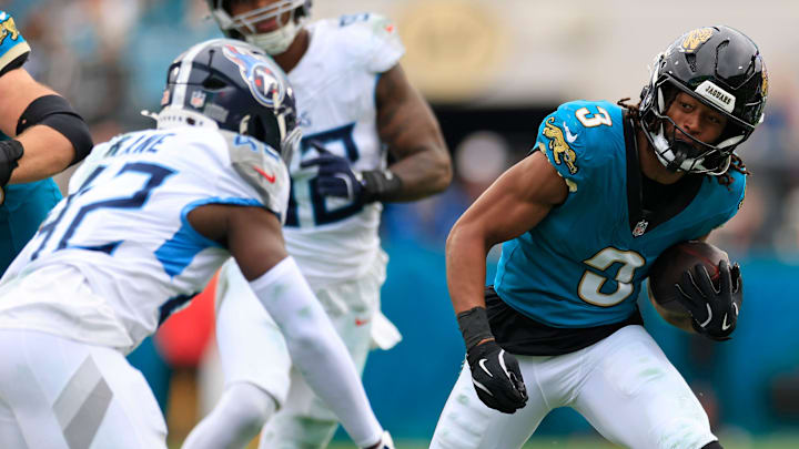 Jacksonville Jaguars wide receiver Jakobi Meyers (3) rushes for yards against Tennessee Titans safety Sanoussi Kane (42) during the fourth quarter of an NFL football matchup at EverBank Stadium, Sunday, Jan. 4, 2026, in Jacksonville, Fla. The Jaguars defeated the Titans 41-7, capturing the AFC South title. [Corey Perrine/Florida Times-Union]