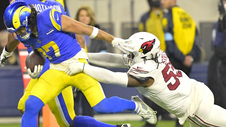 Dec 28, 2024; Inglewood, California, USA;  Los Angeles Rams wide receiver Puka Nacua (17) gains a first down before he is stopped by Arizona Cardinals defensive tackle Dante Stills (55) in the second half at SoFi Stadium. Mandatory Credit: Jayne Kamin-Oncea-Imagn Images
