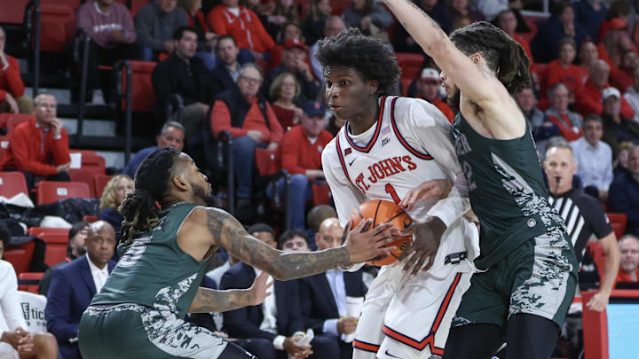 Nov 13, 2024; Queens, New York, USA;  St. John's basketball guard Kadary Richmond (1) looks to drive past Wagner Seahawks guards Zae Blake (5) and Zaire Williams (12) in the second half at Carnesecca Arena.