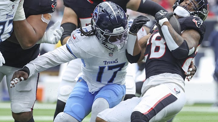 Nov 24, 2024; Houston, Texas, USA; Houston Texans running back Joe Mixon (28) runs with the ball as Tennessee Titans linebacker Jerome Baker (17) attempts to make a tackle during the first quarter at NRG Stadium. Mandatory Credit: Troy Taormina-Imagn Images