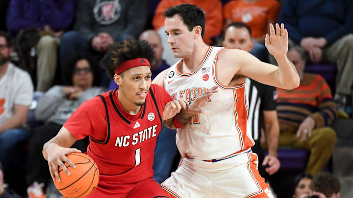 NC State Wolfpack forward Darrion Williams (1) is defended by Clemson Tigers forward Nick Davidson (11) Tuesday, Jan. 20, 2026, during the NCAA men’s basketball game at Littlejohn Coliseum in Clemson, South Carolina.