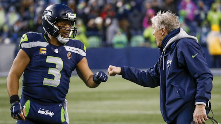 Jan 2, 2022; Seattle, Washington, USA; Seattle Seahawks quarterback Russell Wilson (3) bumps fists with head coach Pete Carroll during the fourth quarter two-minute warning against the Detroit Lions at Lumen Field.