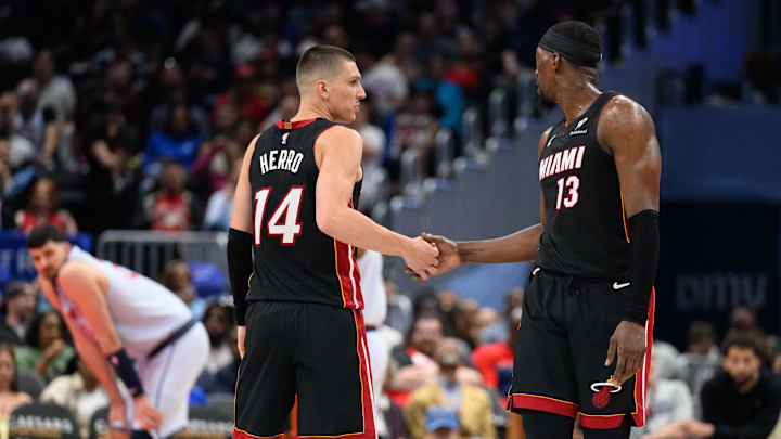 Mar 31, 2025; Washington, District of Columbia, USA; Miami Heat guard Tyler Herro (14) and center Bam Adebayo (13) react during the third quarter against the Washington Wizards at Capital One Arena. Mandatory Credit: Reggie Hildred-Imagn Images