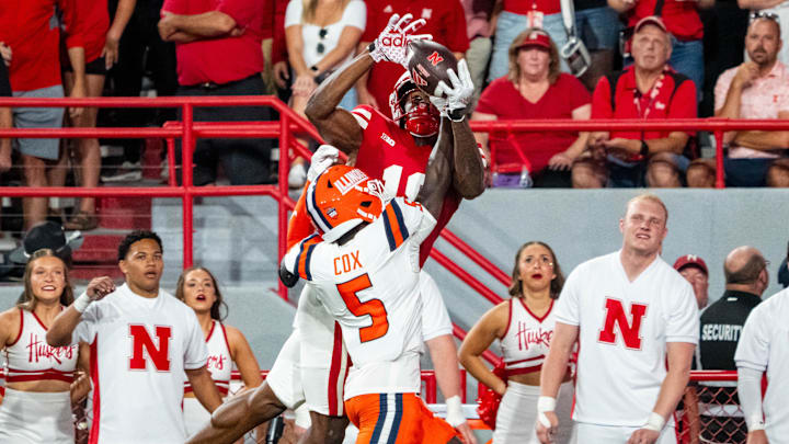 Sep 20, 2024; Lincoln, Nebraska, USA; Illinois Fighting Illini defensive back Torrie Cox Jr. (5) intercepts a pass to Nebraska Cornhuskers wide receiver Isaiah Neyor (18) during the second quarter at Memorial Stadium.