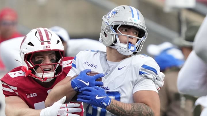 Sep 6, 2025; Madison, Wisconsin, USA; Middle Tennessee Blue Raiders tight end Hunter Tipton (82) is tackled by Wisconsin Badgers linebacker Thomas Heiberger (19) during the second half at Camp Randall Stadium. Mandatory Credit: Kayla Wolf-Imagn Images Sep 6, 2025; Madison, Wisconsin, USA; Middle Tennessee Blue Raiders tight end Hunter Tipton (82) is tackled by Wisconsin Badgers linebacker Thomas Heiberger (19) during the second half at Camp Randall Stadium. Mandatory Credit: Kayla Wolf-Imagn Images