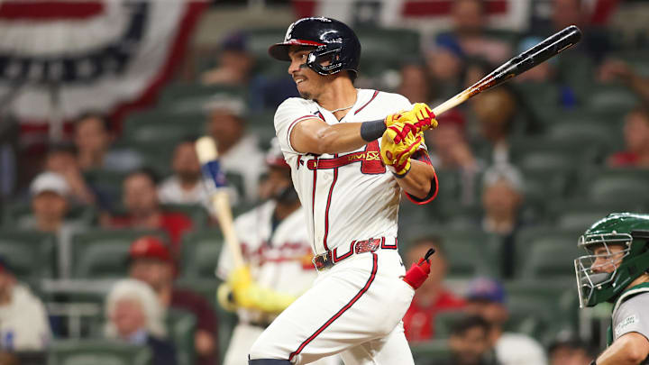 Mar 31, 2026; Atlanta, Georgia, USA; Atlanta Braves second baseman Mauricio Dubon (14) hits a single against the Athletics in the ninth inning at Truist Park. Mandatory Credit: Brett Davis-Imagn Images
