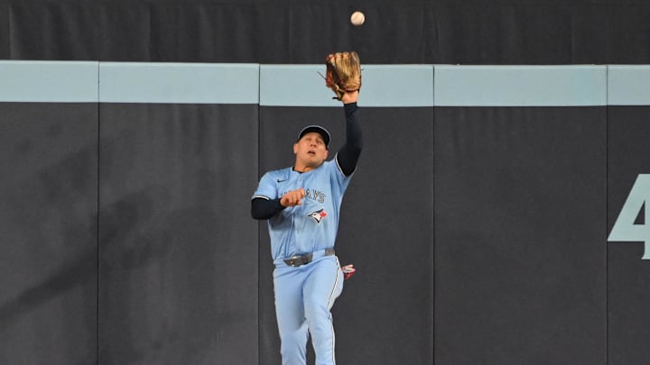 May 1, 2025; Toronto, Ontario, CAN;  Toronto Blue Jays center fielder Daulton Varsho (5) catches a fly ball hit by Boston Red Sox right fielder Wilyer Abreu (not shown) in the first inning at Rogers Centre. 