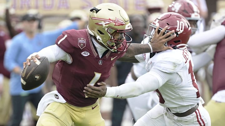 Aug 30, 2025; Tallahassee, Florida, USA; Florida State Seminoles quarterback Tommy Castellanos (1) stiff arms Alabama Crimson Tide linebacker Justin Jefferson (10) during the second half at Doak S. Campbell Stadium. Mandatory Credit: Melina Myers-Imagn Images