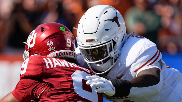 Texas Longhorns linebacker Colin Simmons (11) brings down Oklahoma Sooners quarterback Michael Hawkins Jr. (9) during the Red River Rivalry college football game between the University of Oklahoma Sooners (OU) and the Texas Longhorns at the Cotton Bowl in Dallas, Oct. 12, 2024. Texas won 34-3.