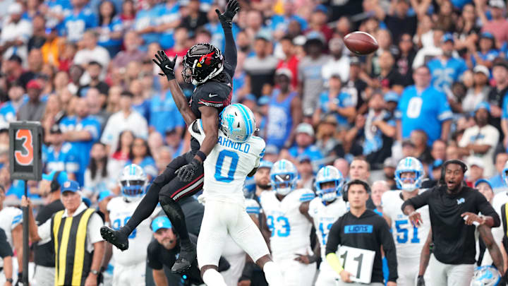  Detroit Lions cornerback Terrion Arnold (0) defends a pass to Arizona Cardinals wide receiver Marvin Harrison Jr. (18) 