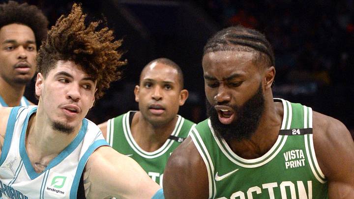 Mar 9, 2022; Charlotte, North Carolina, USA;  Boston Celtics guard Jaylen Brown (7) is fouled by Charlotte Hornets guard LaMelo Ball (2) during the second half at the Spectrum Center. Mandatory Credit: Sam Sharpe-Imagn Images