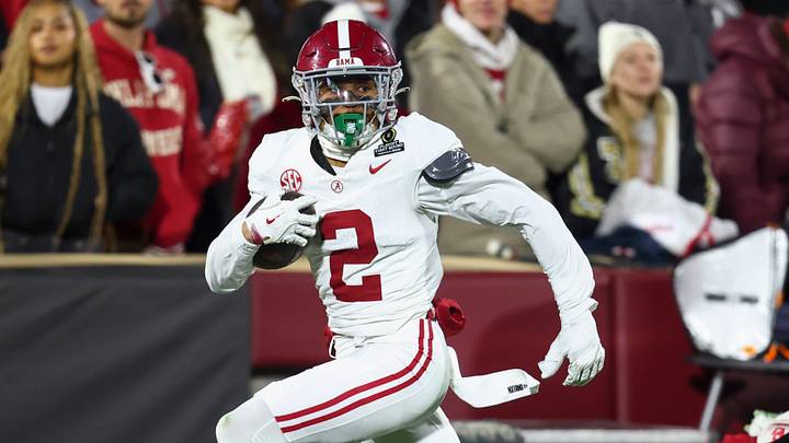 Dec 19, 2025; Norman, OK, USA; Alabama Crimson Tide defensive back Zabien Brown (2) eludes a tackle by Oklahoma Sooners quarterback John Mateer (10) in the first half at Gaylord Family OK Memorial Stadium. Mandatory Credit: Mark J. Rebilas-Imagn Images