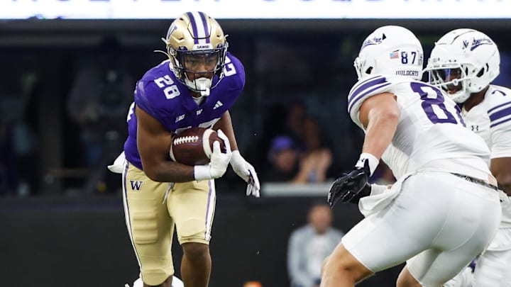Sep 21, 2024; Seattle, Washington, USA; Washington Huskies linebacker Khmori House (28) returns an interception against the Northwestern Wildcats during the fourth quarter at Alaska Airlines Field at Husky Stadium. Mandatory Credit: Joe Nicholson-Imagn Images Sep 21, 2024; Seattle, Washington, USA; Washington Huskies linebacker Khmori House (28) returns an interception against the Northwestern Wildcats during the fourth quarter at Alaska Airlines Field at Husky Stadium. Mandatory Credit: Joe Nicholson-Imagn Images