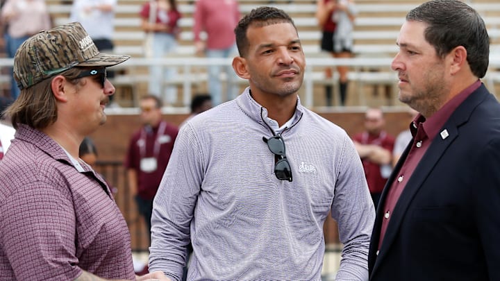 Country musician Hardy, Mississippi State Bulldogs athletic  director Zac Selmon and coach Jeff Lebby talk prior to the game against the Texas Longhorns at Davis Wade Stadium at Scott Field in Starkville, Miss.