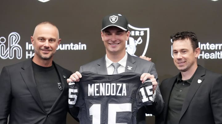 Apr 24, 2026; Henderson, NV, USA; Las Vegas Raiders quarterback Fernando Mendoza (center) poses with jersey with general manager John Spytek (left) and head coach Klint Kubiak  at introductory press conference at Intermountain Health Performance Center after being selected as the No. 1 pick in the 2026 NFL Draft. Mandatory Credit: Kirby Lee-Imagn Images