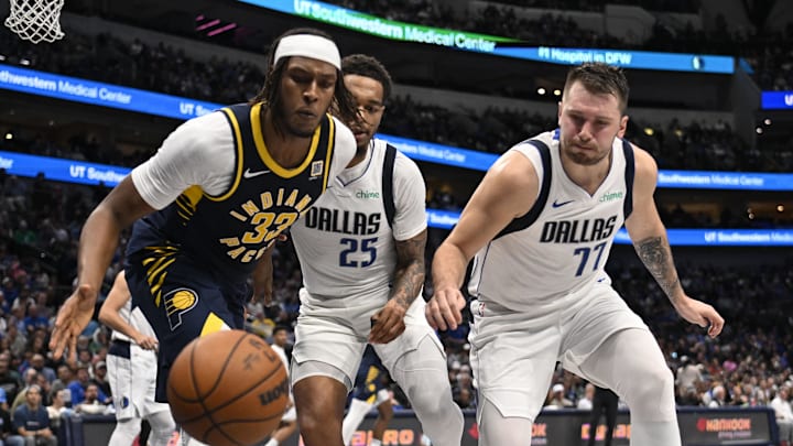 Nov 4, 2024; Dallas, Texas, USA; Indiana Pacers center Myles Turner (33) and Dallas Mavericks guard Luka Doncic (77) look for the loose ball during the second quarter at the American Airlines Center. Mandatory Credit: Jerome Miron-Imagn Images