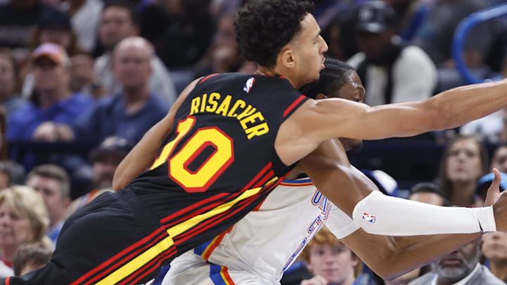 Oct 27, 2024; Oklahoma City, Oklahoma, USA; Atlanta Hawks forward Zaccharie Risacher (10) and Oklahoma City Thunder forward Jalen Williams (8) reach for a loose ball during the second quarter at Paycom Center. Mandatory Credit: Alonzo Adams-Imagn Images