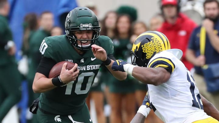 Michigan State Spartans quarterback Payton Thorne is tackled by Michigan Wolverines defensive back Daxton Hill (30) and linebacker Josh Ross (12) during the second half Saturday, Oct. 30, 2021 at Spartan Stadium in East Lansing. Michigan State Spartans quarterback Payton Thorne is tackled by Michigan Wolverines defensive back Daxton Hill (30) and linebacker Josh Ross (12) during the second half Saturday, Oct. 30, 2021 at Spartan Stadium in East Lansing.