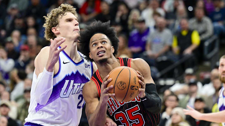 Nov 16, 2025; Salt Lake City, Utah, USA; Chicago Bulls forward/guard Isaac Okoro (35) drives around Utah Jazz forward/center Lauri Markkanen (23) during the second half at Delta Center. Mandatory Credit: Peter Creveling-Imagn Images