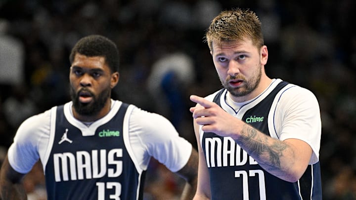 Nov 19, 2024; Dallas, Texas, USA; Dallas Mavericks guard Luka Doncic (77) motions to his teammates as forward Naji Marshall (13) looks on during the second half against the New Orleans Pelicans at the American Airlines Center. Mandatory Credit: Jerome Miron-Imagn Images