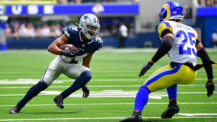 Aug 11, 2024; Inglewood, California, USA; Dallas Cowboys running back Malik Davis (34) runs the ball against Los Angeles Rams safety Jason Taylor II (25) during the first half at SoFi Stadium. Mandatory Credit: Gary A. Vasquez-USA TODAY Sports