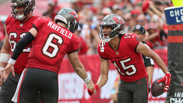 Dec 29, 2024; Tampa, Florida, USA; Tampa Bay Buccaneers wide receiver Jalen McMillan (15) is congratulated by quarterback Baker Mayfield (6) after he scored a touchdown  against the Carolina Panthers during the second quarter at Raymond James Stadium. Mandatory Credit: Kim Klement Neitzel-Imagn Images