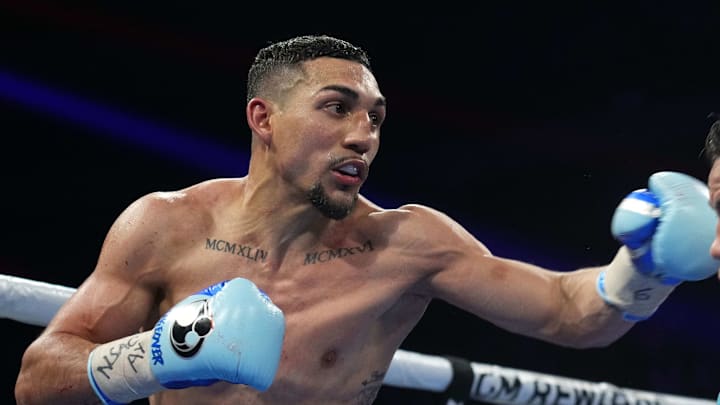 Feb 8, 2024; Las Vegas, Nevada, USA;  Teofimo Lopez (black/gold/red trunks) and Jamaine Ortiz (black trunks) box during their WBO Junior Welterweight World Title bout at Michelob ULTRA Arena. Mandatory Credit: Joe Camporeale-Imagn Images